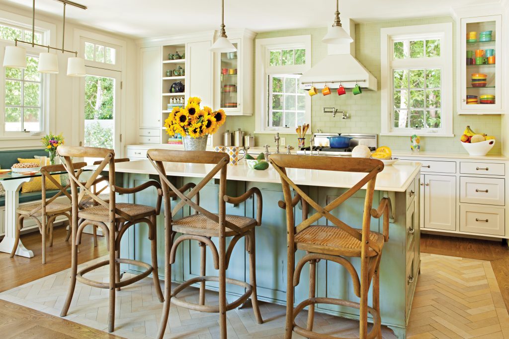 Kitchen Banquette in the background with wooden country style bar stools lined up at the kitchen island. 