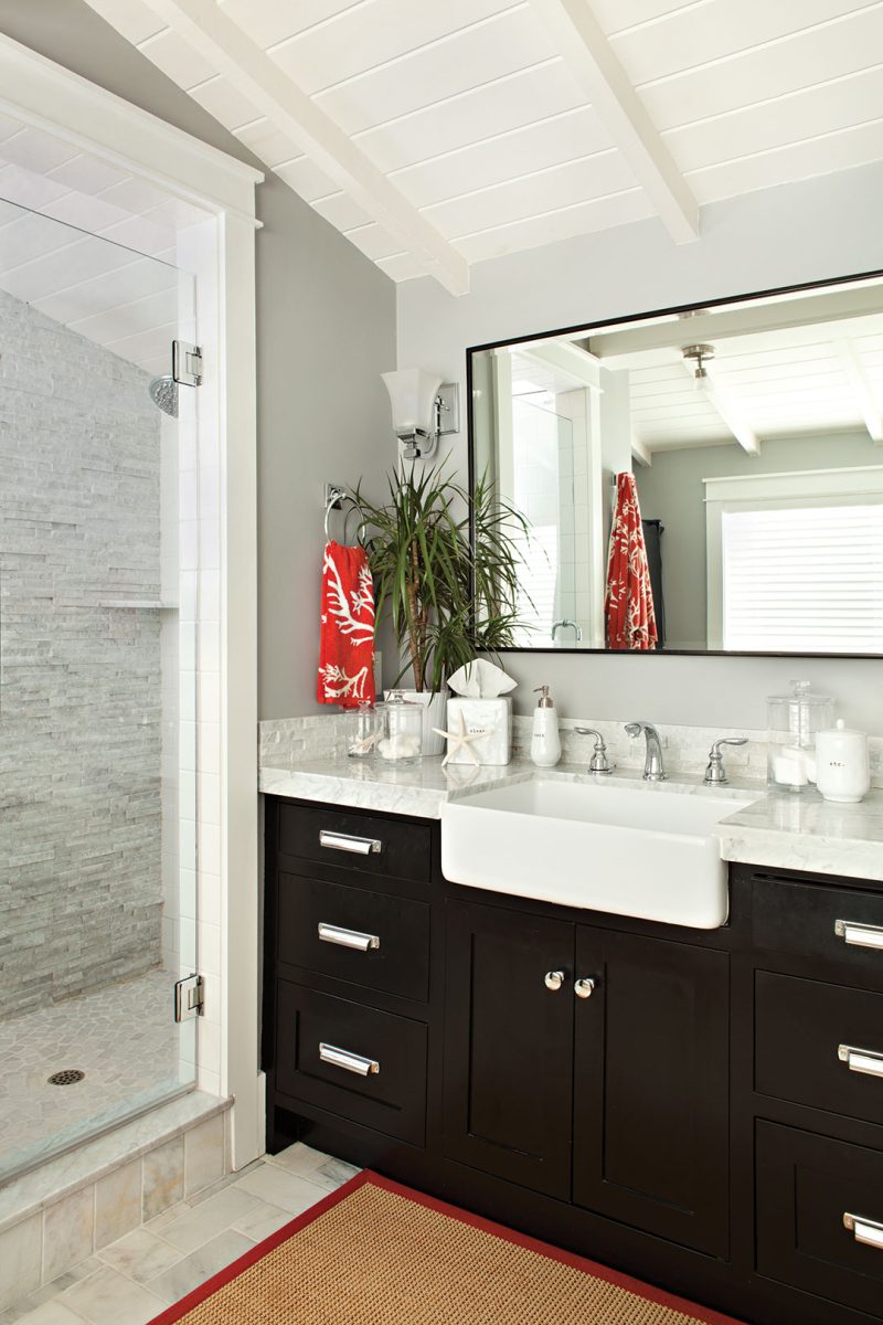 Master bathroom decor with dark wood cabinetry and a gray color scheme.