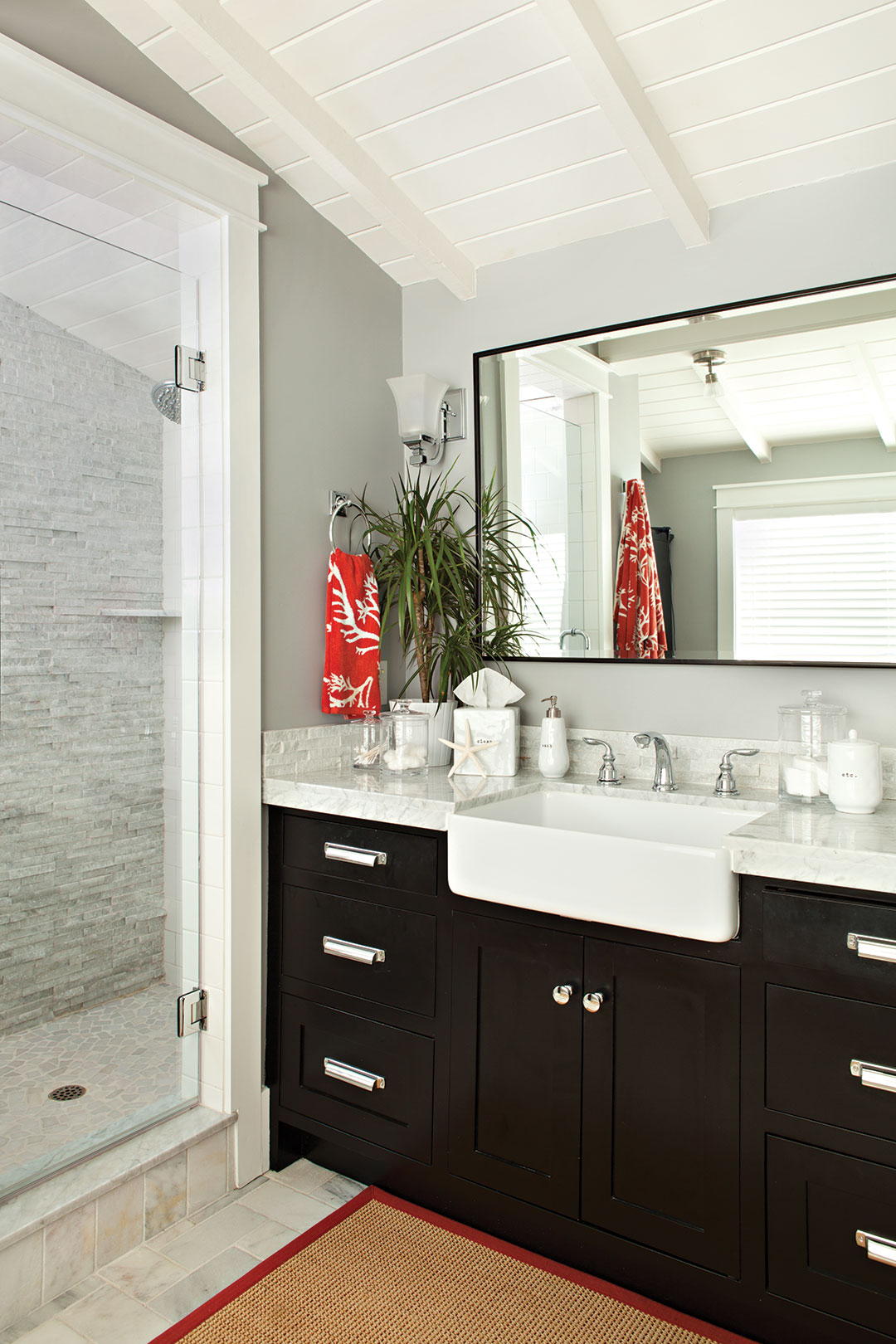 Master bathroom decor with dark wood cabinetry and a gray color scheme. 