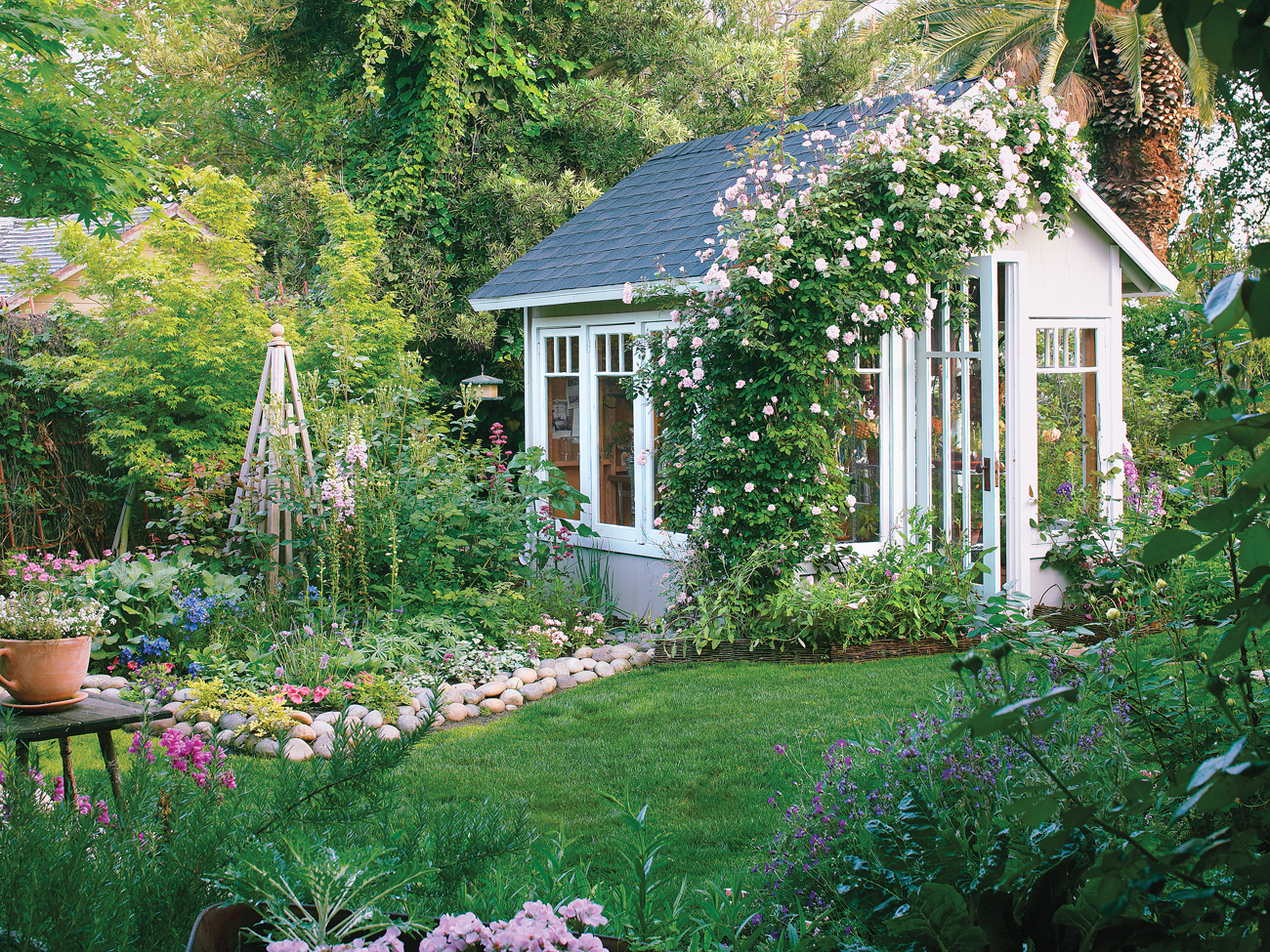 Image of Small garden with a boxwood-lined path and a hydrangea-filled arbor