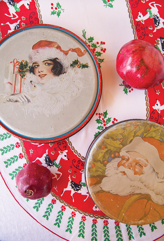 Vintage cookie tins featuring Santa and snow-filled themes. 