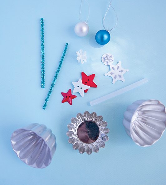 pipe cleaners, star buttons and mini ornaments are all ingredients for turning a mini candy mold into a new ornament