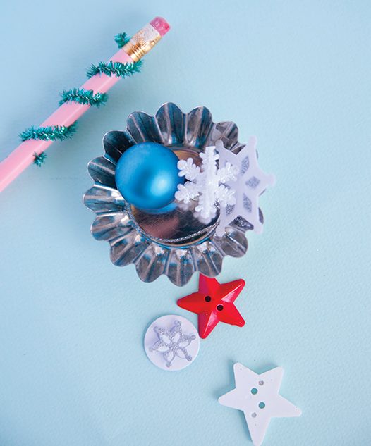 pipe cleaners, star buttons and mini ornaments are all ingredients for turning a mini candy mold into a new ornament