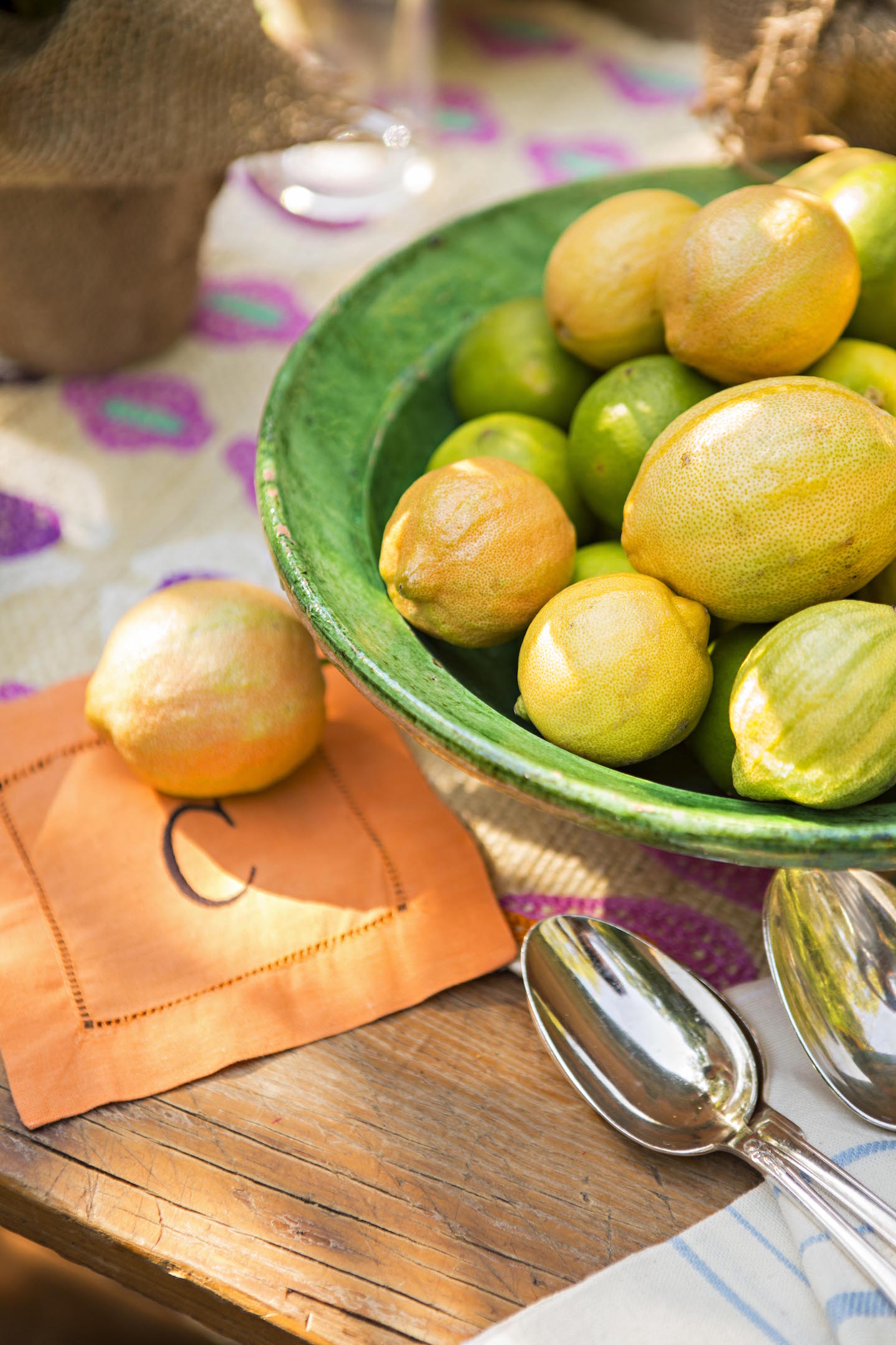 pink lemons in a green ceramic bowl.