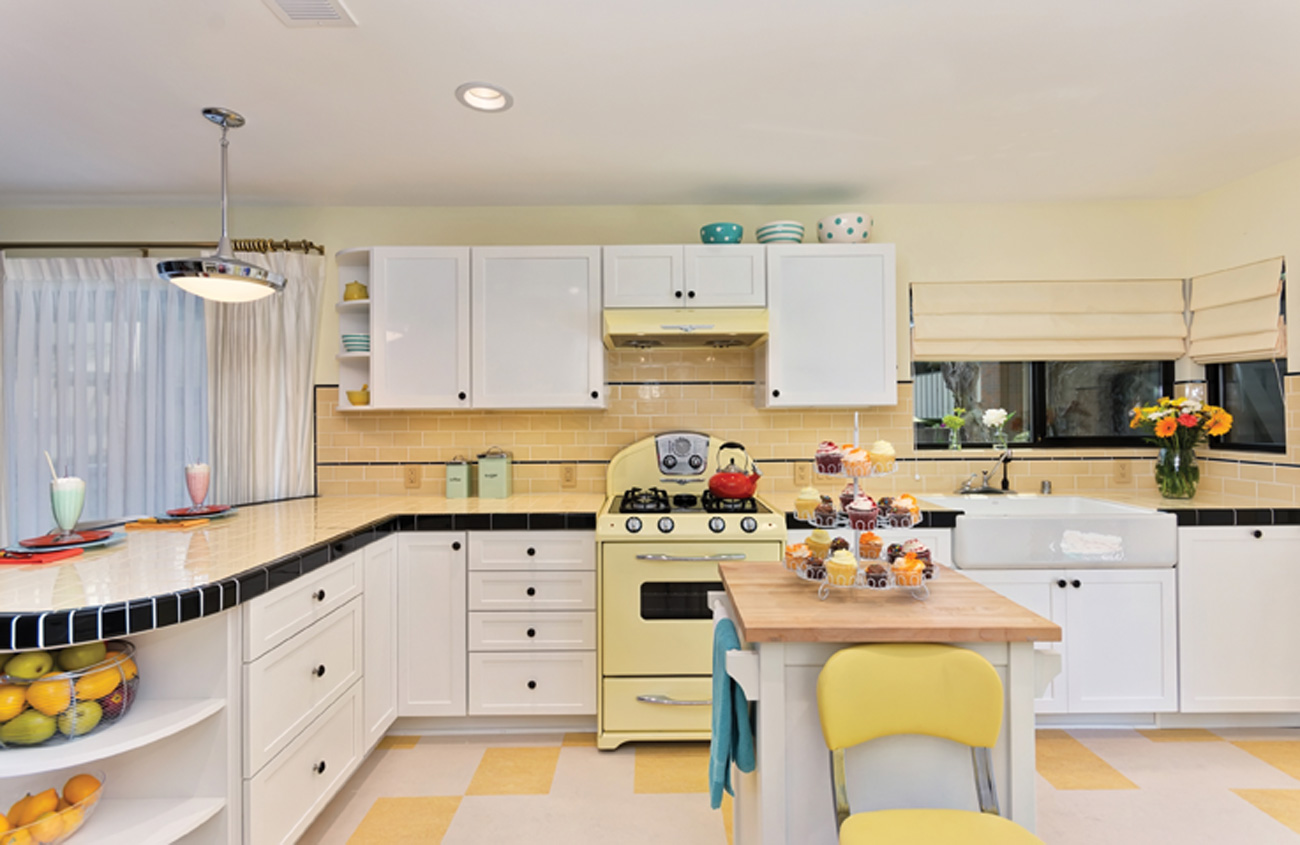 Yellow checkered kitchen floor with retro buttercup oven in a wide angled kitchen photo