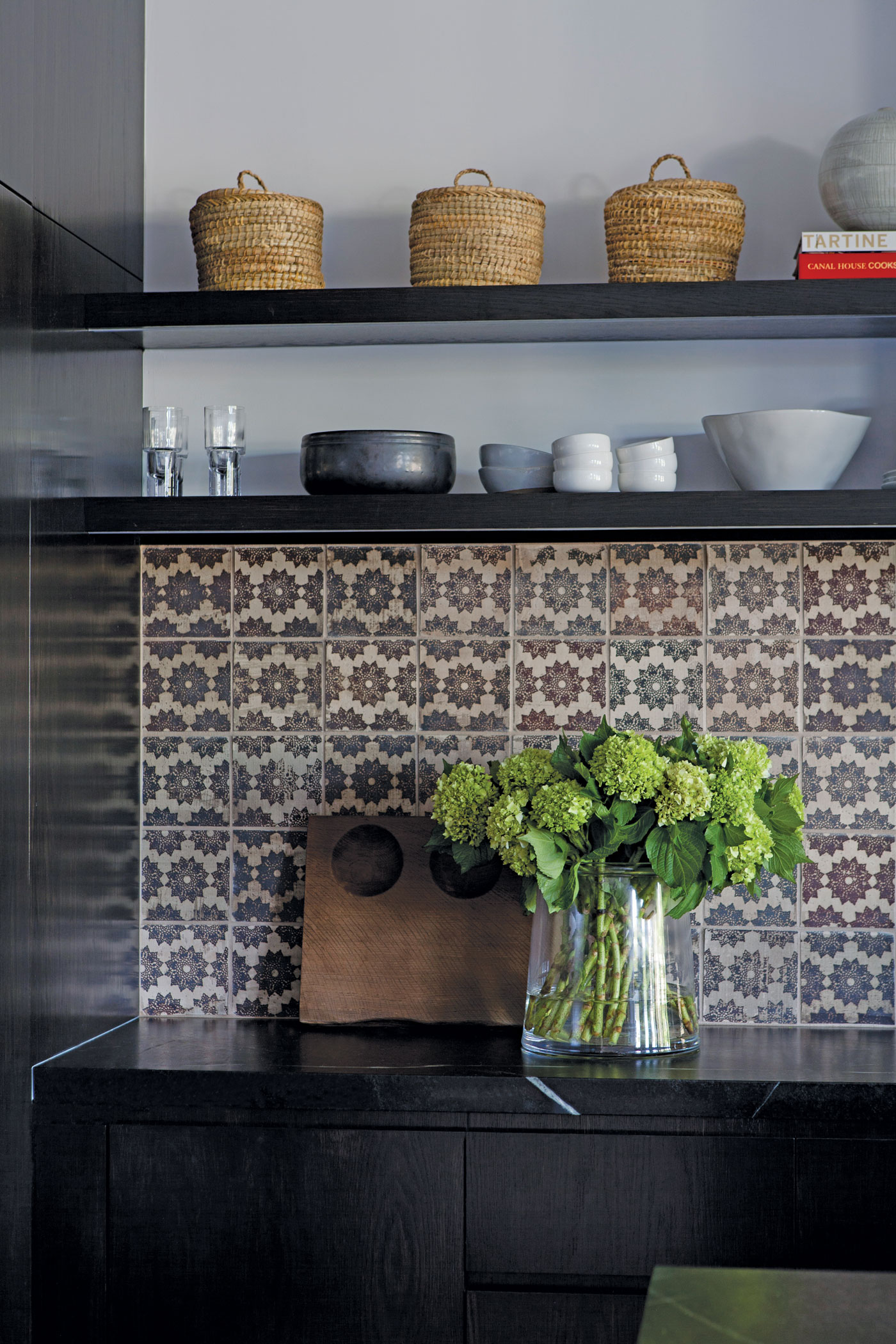 Dark Kitchen accents and tile backsplash with built in shelves