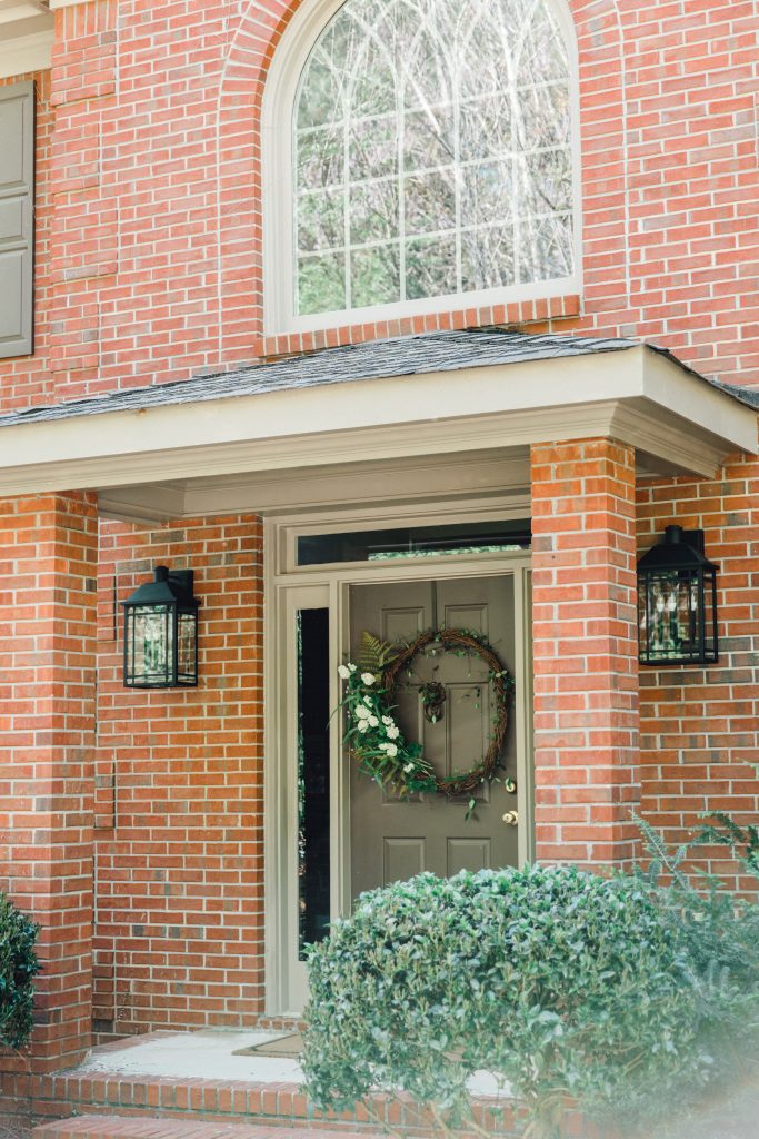 Braden Lankford Lanterns Hanging on the front porch of a brick home