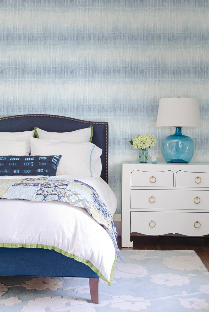 Pretty blue and white wallpaper which looks like a cross between ombre and ikat, gives a cool textural affect to this on-trend yet timeless bedroom. 