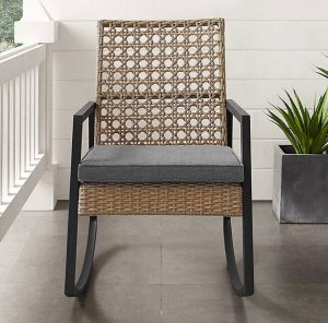 cane back outdoor rocker on a front cottage style porch