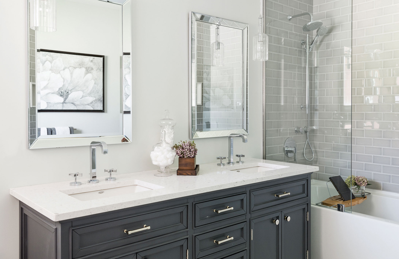 Vanity cover with black cabinetry and white countertops