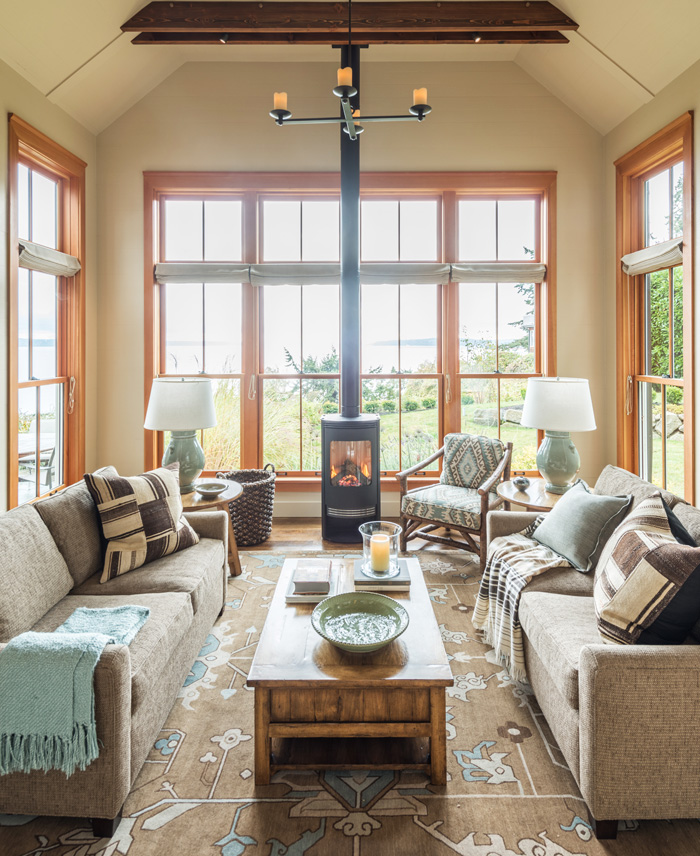 Open living room with large windows in Bainbridge Island cottage