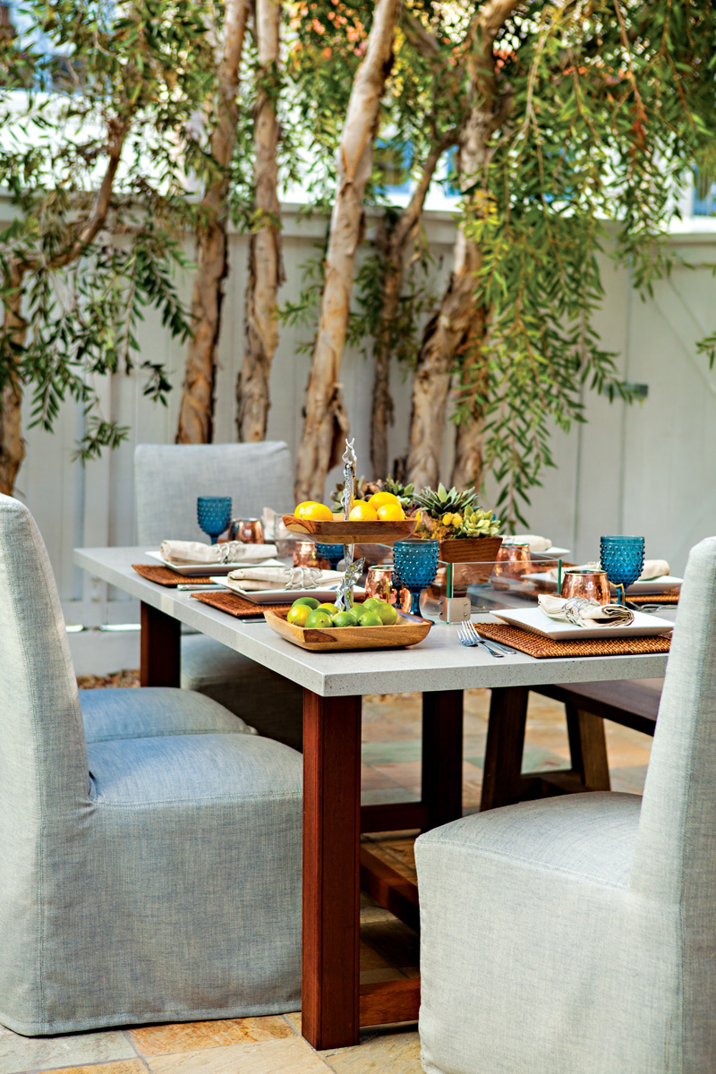 Patio dining table with elegant chairs and blue accents
