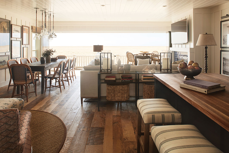 neutral colored living space with wall of windows with an ocean view