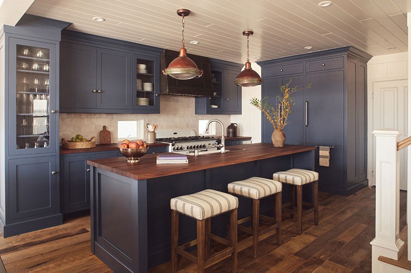 Blue cabinetry kitchen with neutral colored vintage accents