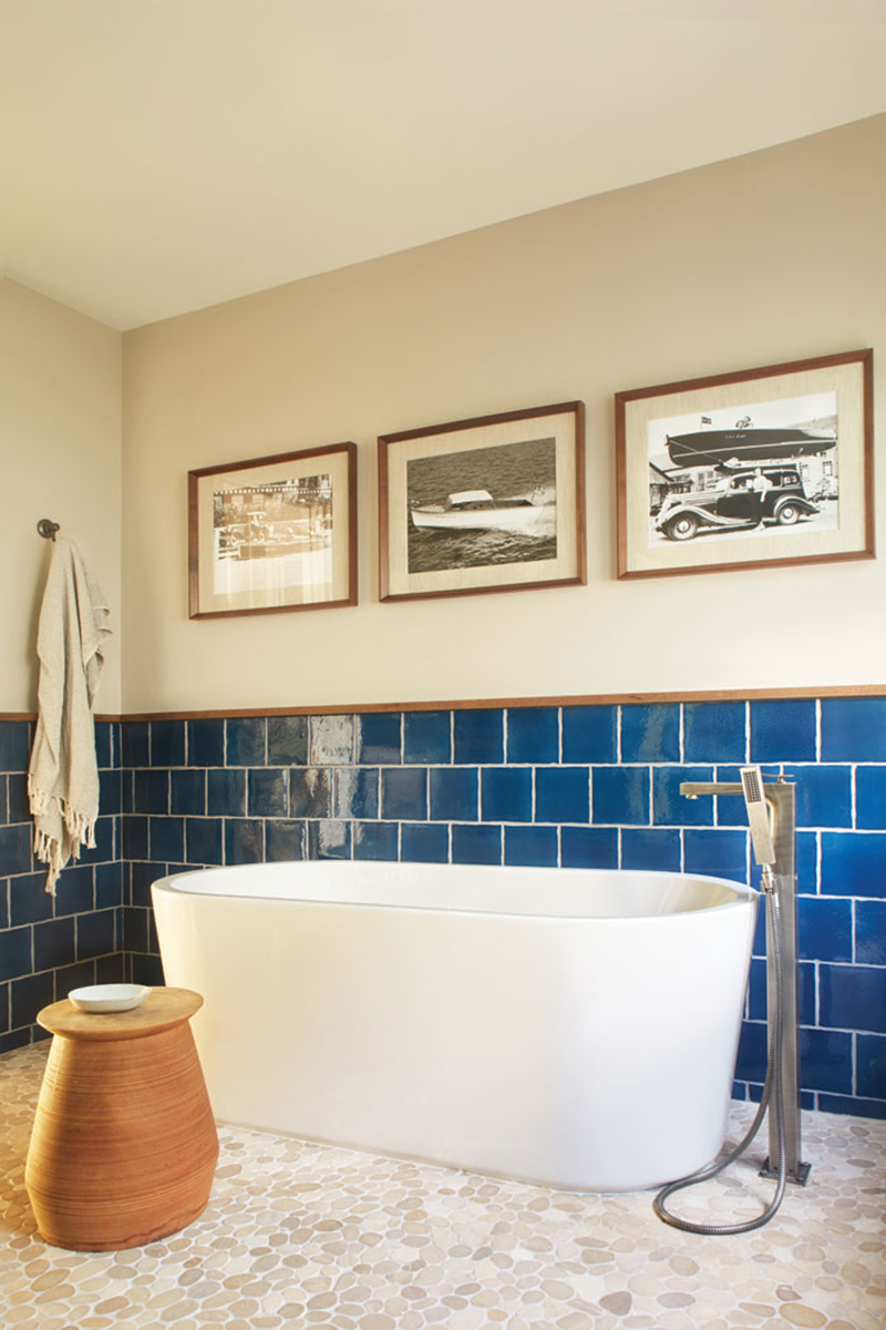 Blue bathroom wall backsplash with modern tub