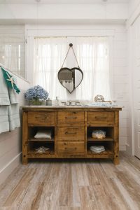 rustic wood vanity in small bathroom nook surrounded by white shiplap walls