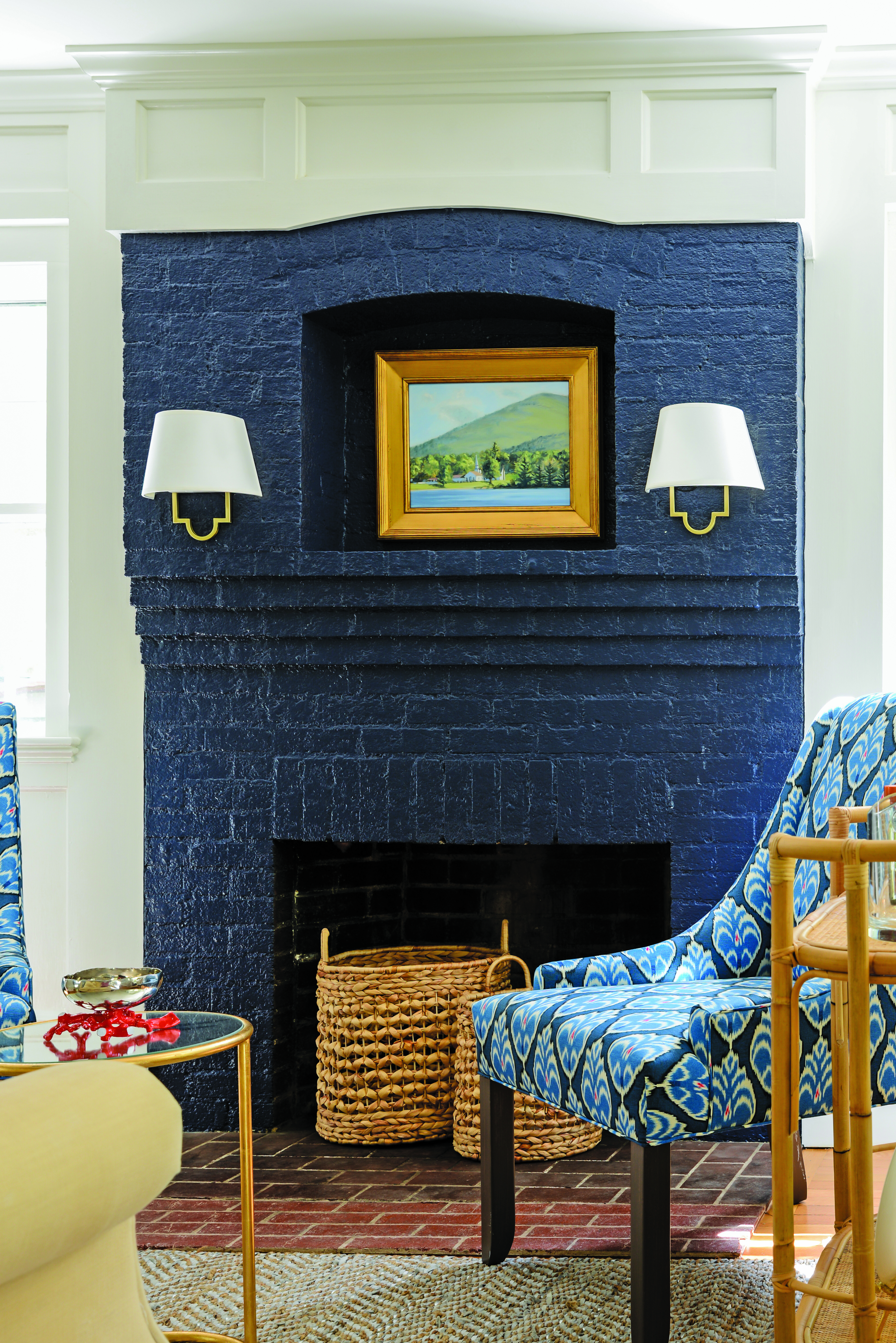 This navy-blue lacquered fireplace ties in perfectly with the patterned accent chair and wall art.