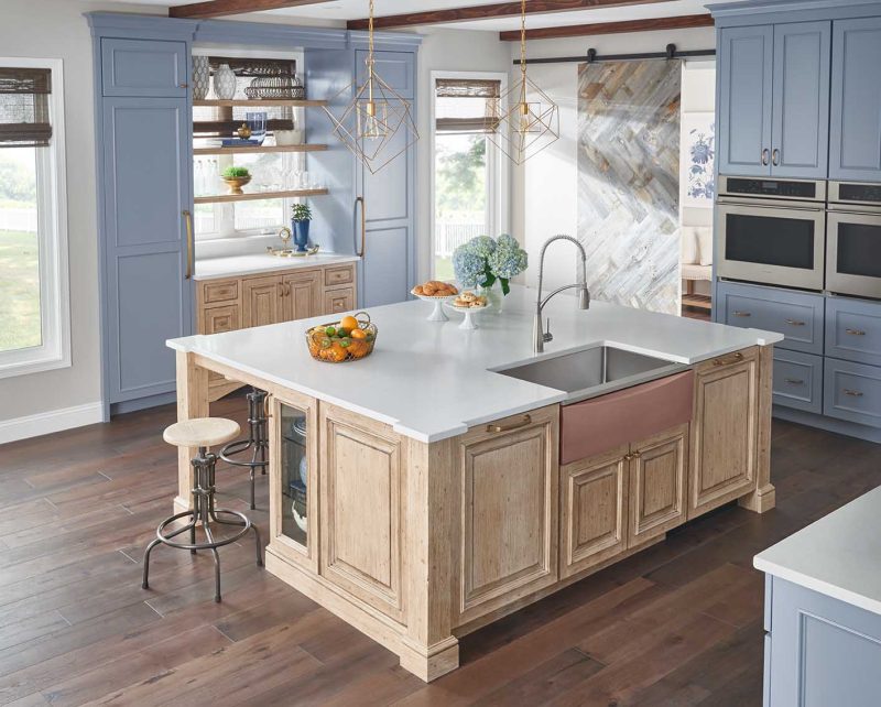 The Elkay Crosstown Stainless Steel Farmhouse Sink with Interchangeable Apron is shown in bold blue. The apron switches out in minutes comes in seven colors and materials so you can customize it to match your mood!