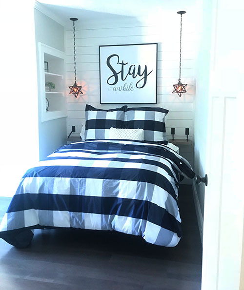 Bedroom with white shiplap wall.