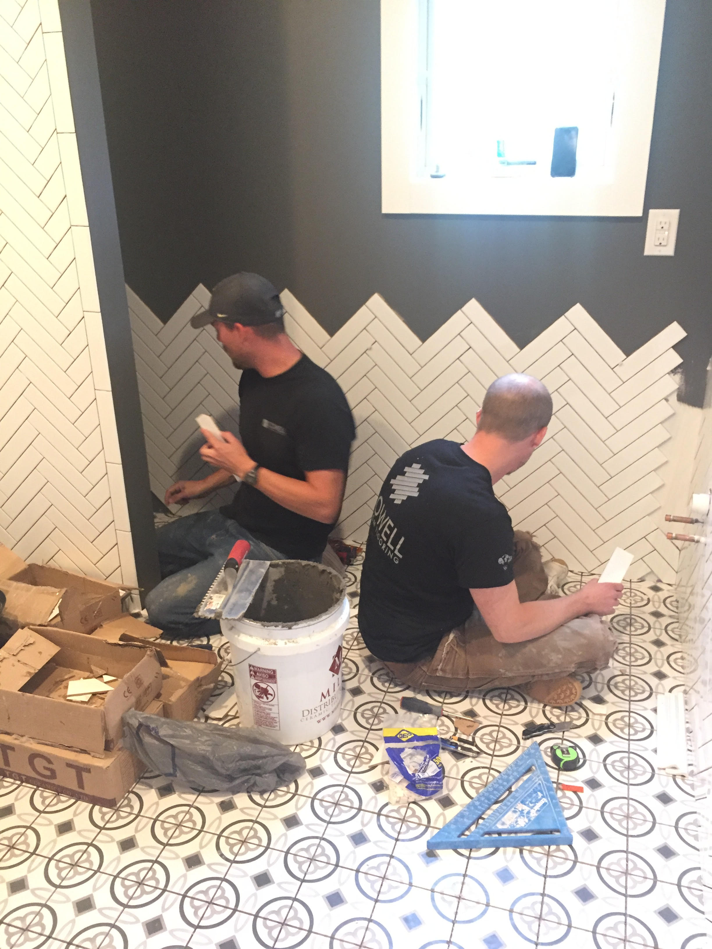 The tile floors and herringbone-pattern wall subway tile will be featured in the upstairs guest bathroom, shown here.