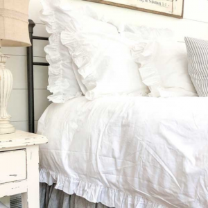 Farmhouse style white ruffled duvet set .