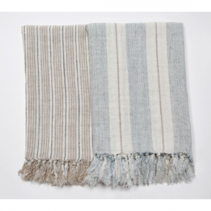 Light colored linen throw blankets with fringe.