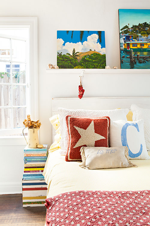 Cozy bedroom with stacked-book side table.