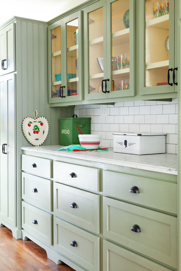 bungalow butler's pantry makeover with custom soft green cabinetry with white subway tile backsplash.