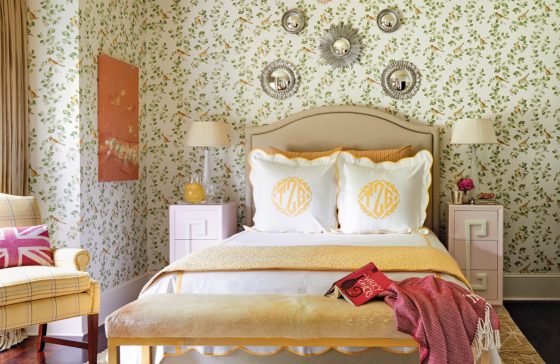 Guest bedroom with patterned wallpaper.