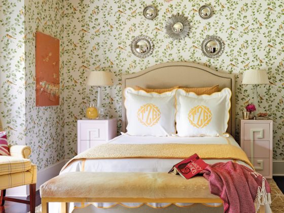 Guest bedroom with patterned wallpaper.