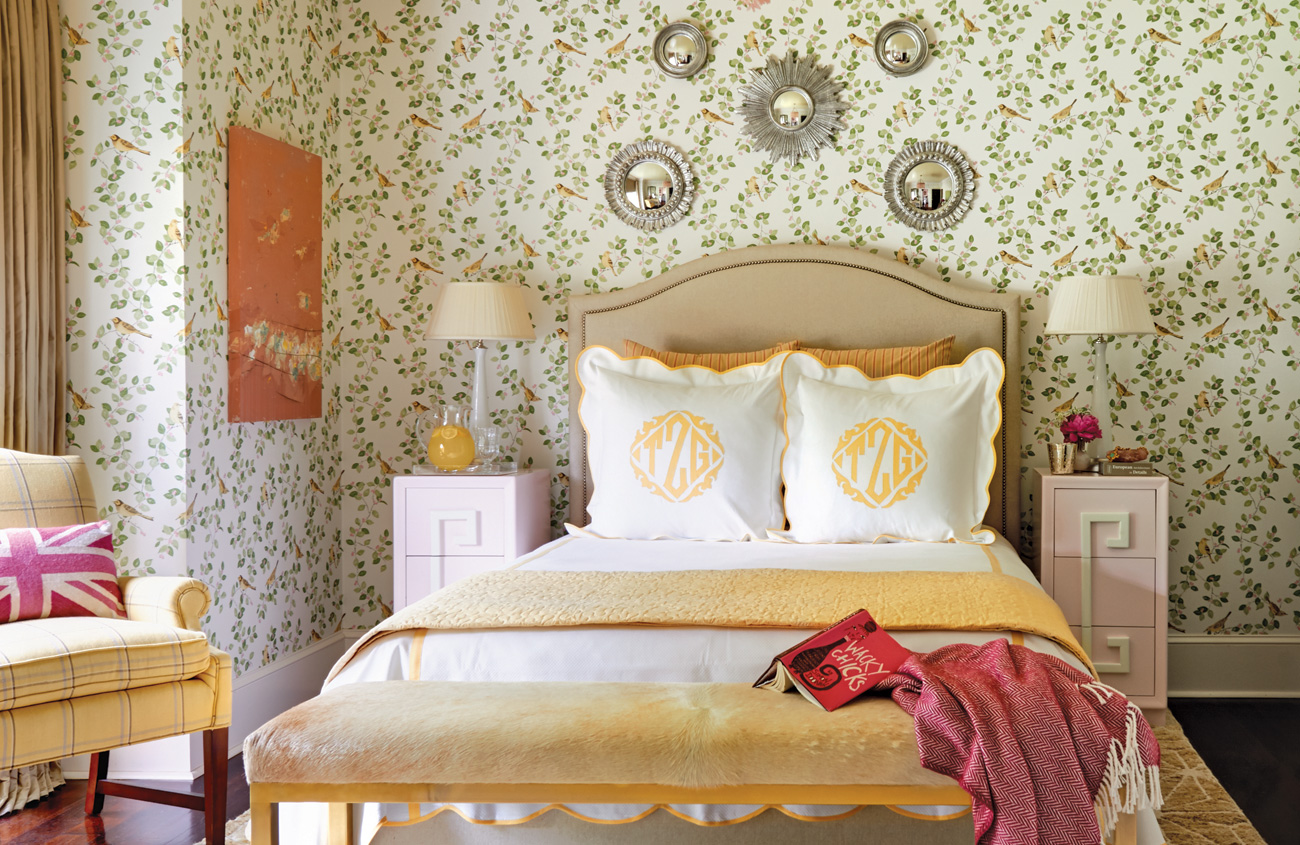 Guest bedroom with patterned wallpaper.