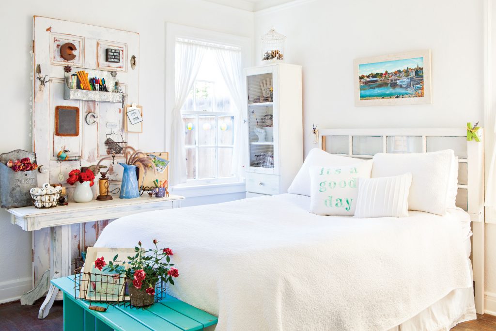 All-white guest bedroom with pops of light blue.