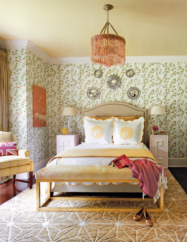 Full guest bedroom with patterned wallpaper and yellow décor accents.