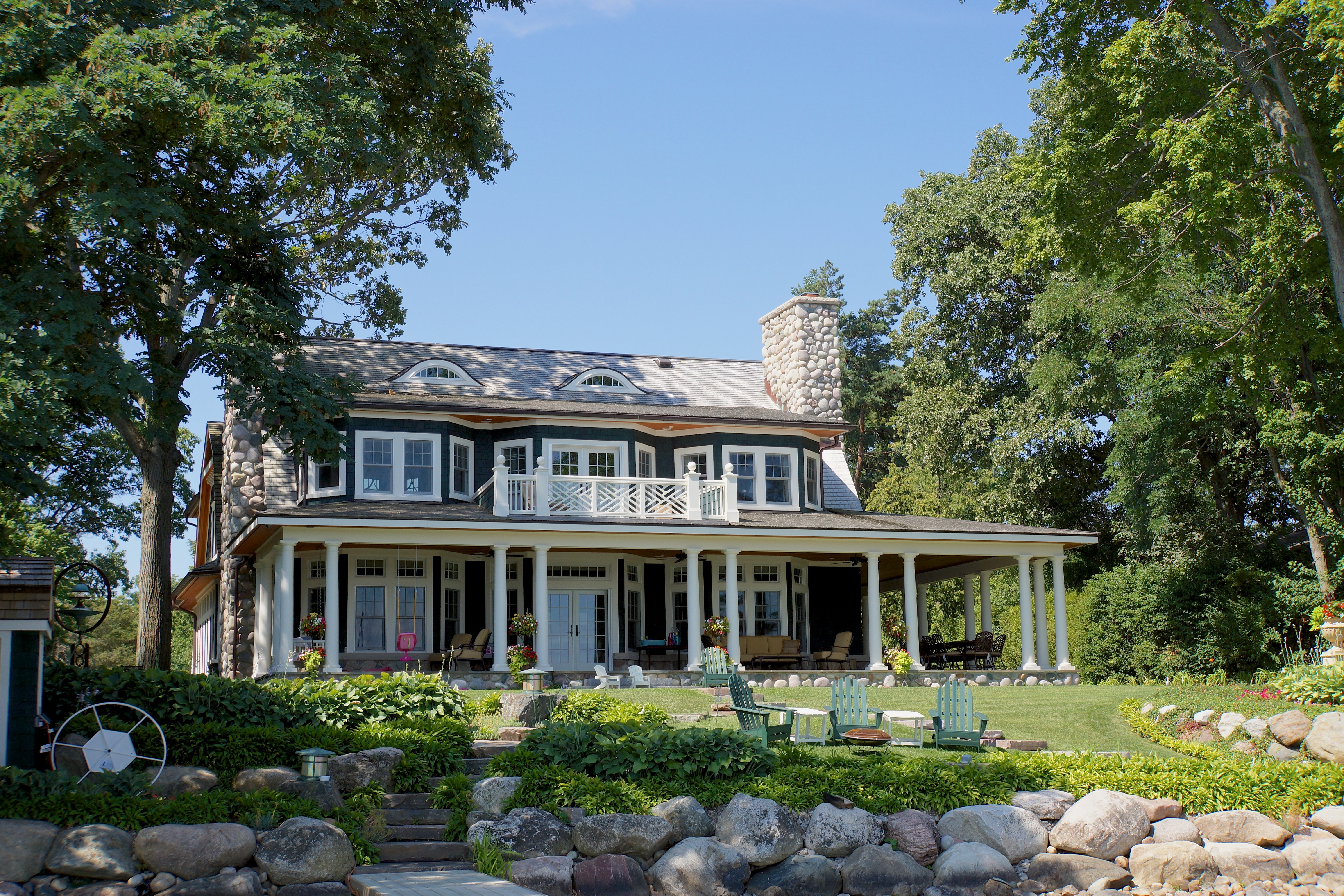 Lakeside house with large back porch and lots of windows in suburban Michigan.