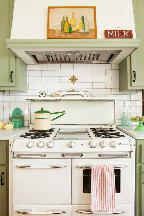 vintage stove in a bungalow kitchen makeover with light green cabinetry