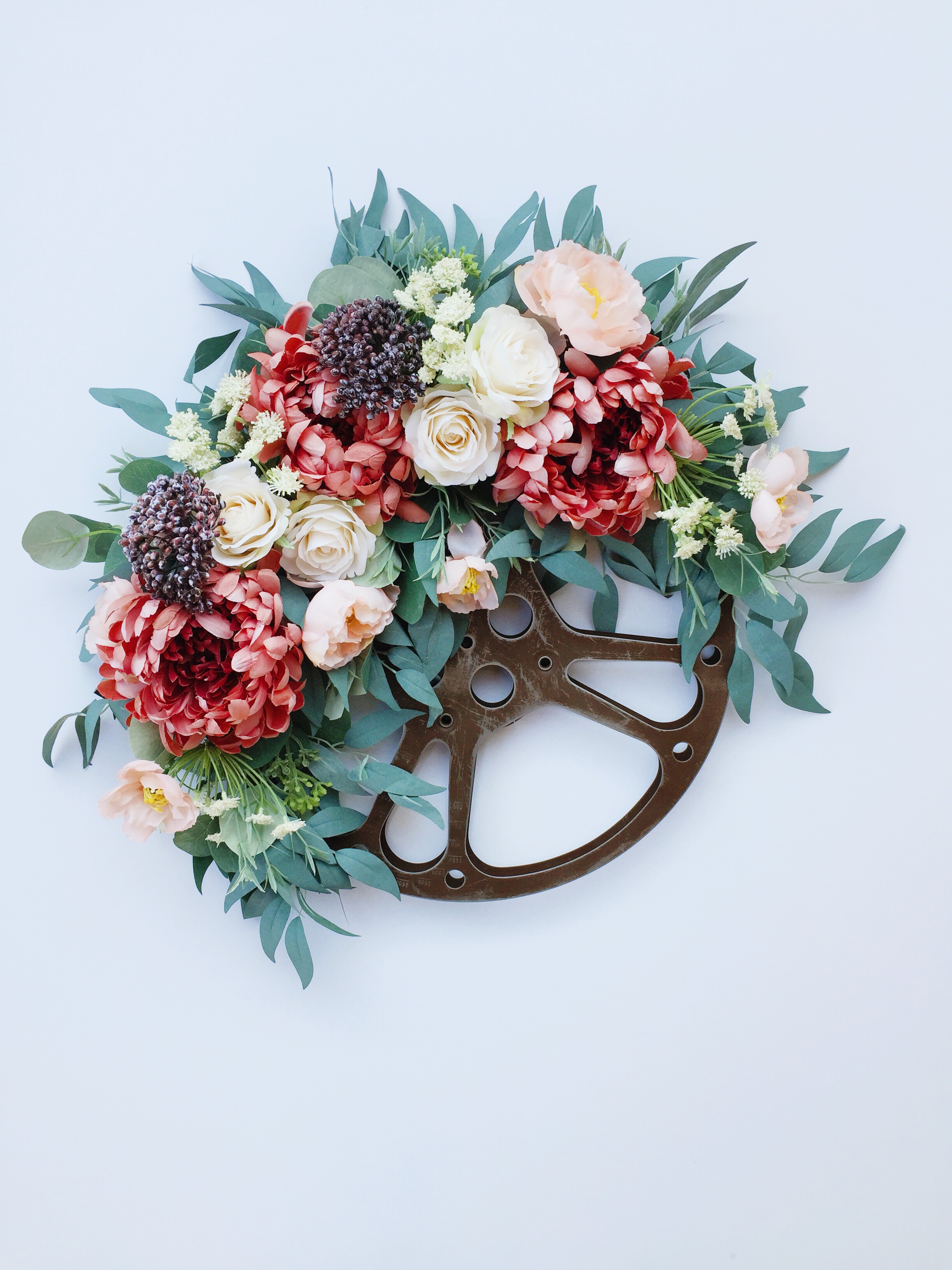 Round floral decorative wreath with greenery from Bloom Valley Market.