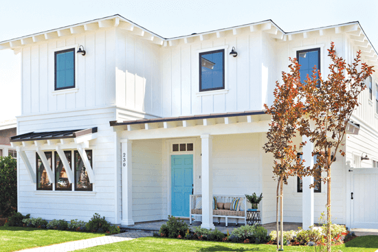 To balance the nautical with the rustic, Kate chose a blue front door, white exterior and comfy, beach-inspired seating with accent pillows.