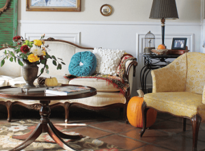fall decorating with vintage pitcher and furniture along with pumpkins and fall flowers