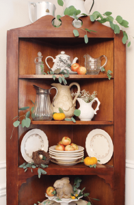apples and small pumpkins on hutch display shelves along with vintage kitchenalia