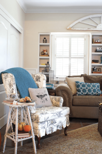 vintage side table with decorative pumpkins in cottage living room