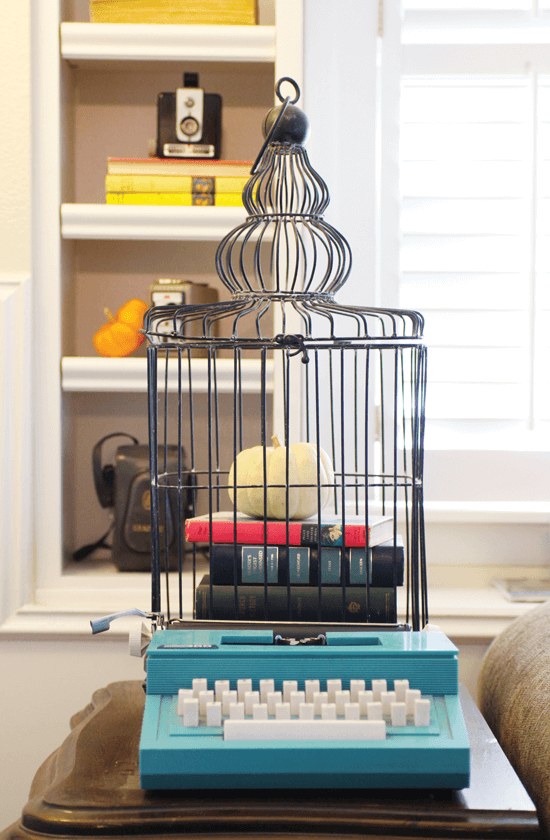 vintage fall decorating with typewriter and birdcage vignette with white pumpkin