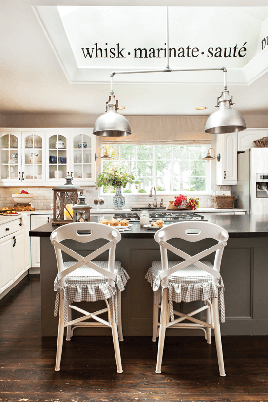 DIY pendant lights connected with pipe from a hardware store, shown here above the kitchen island.