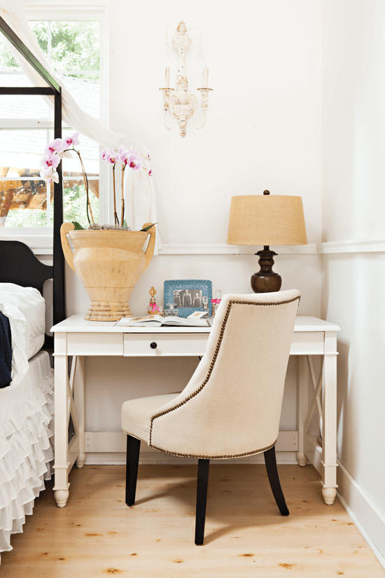 This upholstered desk chair adds a classic touch to the overall casual-chic room.