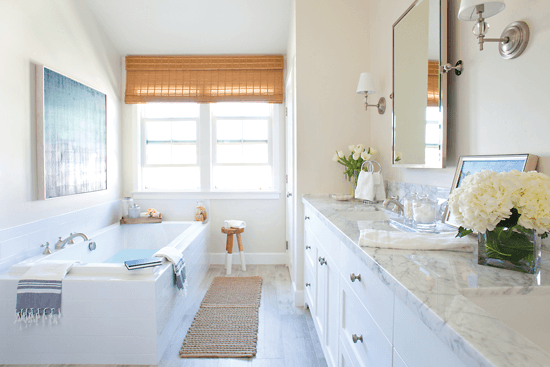 White marble, polished chrome and natural materials add a softness to the master bath in this beach cottage.