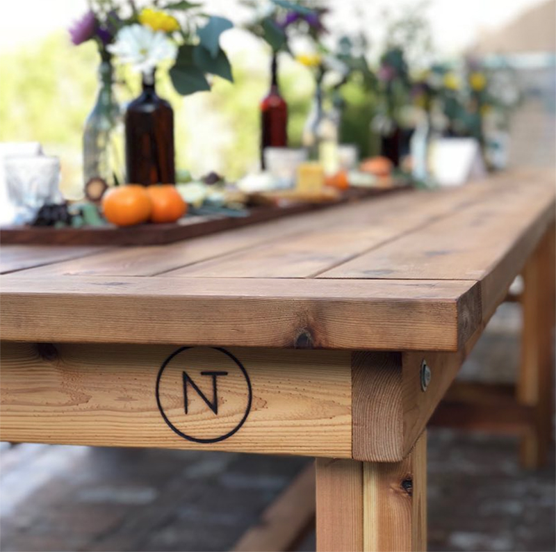 The classic wood table is a 9ft farmhouse-style table with wood benches and an authentic Neighbor’s Table stamp. The tables’ cedar material makes them perfect for outside use and allows them to last through years of meals and gatherings.