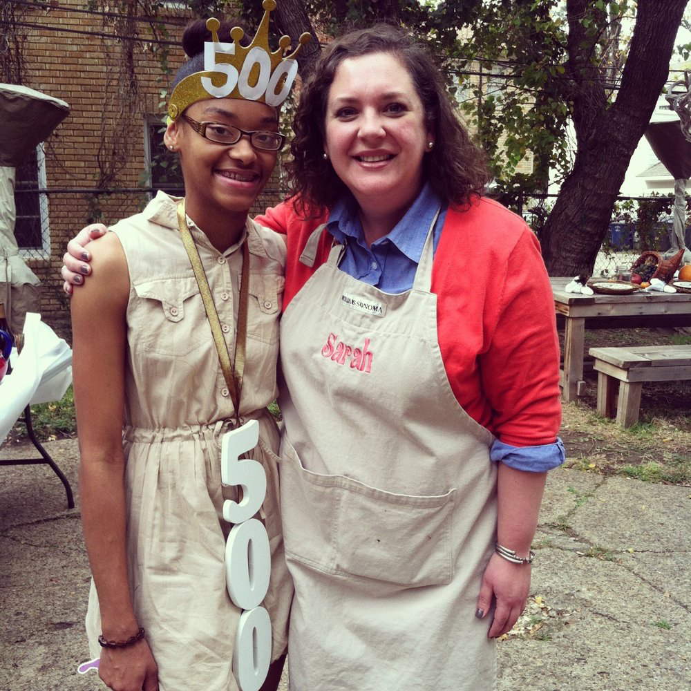 Founder of Neighbor's Table, Sarah (right), pictured with her 500th guest (left), who she welcomed on Thanksgiving Day of 2012.