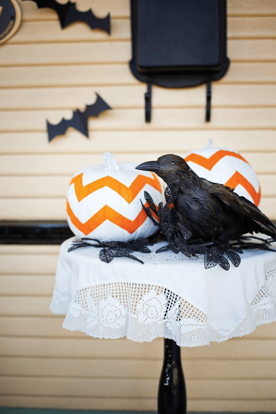 Create an easy display by using a small side table is topped with a cutwork tablecloth to enhance the farmhouse architecture of the cottage.