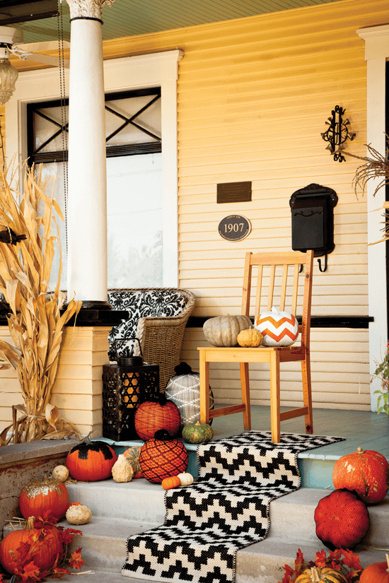 Don’t be afraid to accessorize your Halloween porch with an indoor eye towards elegance and texture. Here, we added a graphic tribal-style runner to this Halloween porch décor.