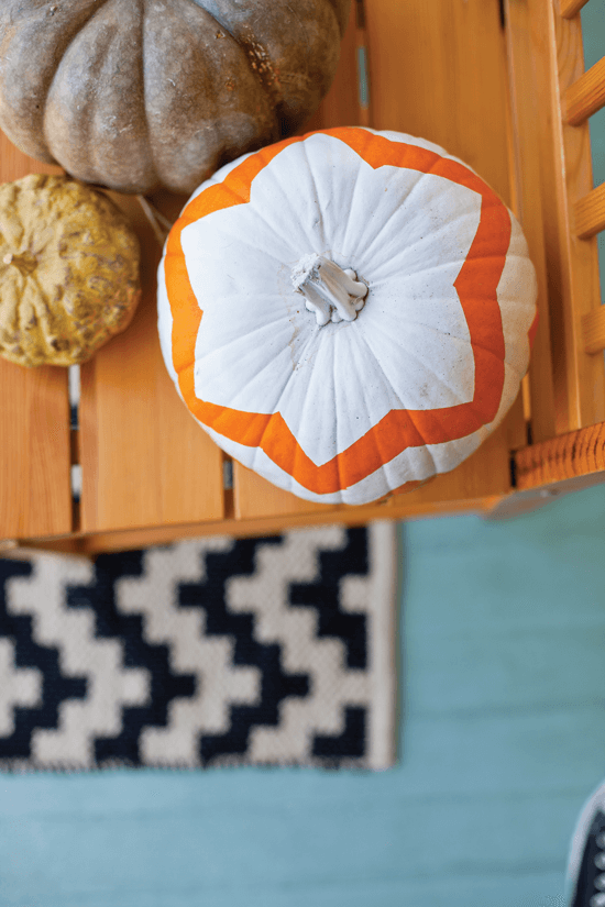 Our other favorite way to decorate pumpkins involves two easy ingredients: paint and painter’s tape. Just mask off a pattern of your choice around your pumpkin, paint a few layers and then carefully peel off the tape to reveal your crisp design.