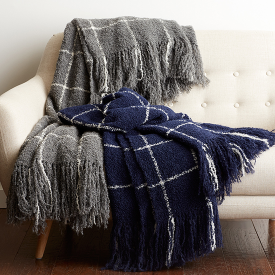 The Alpaca Bouclè Check Throw from The Company Store, shown here in navy and dark gray. These throw blankets are 100% yarn-dyed alpaca and luxuriously warm.